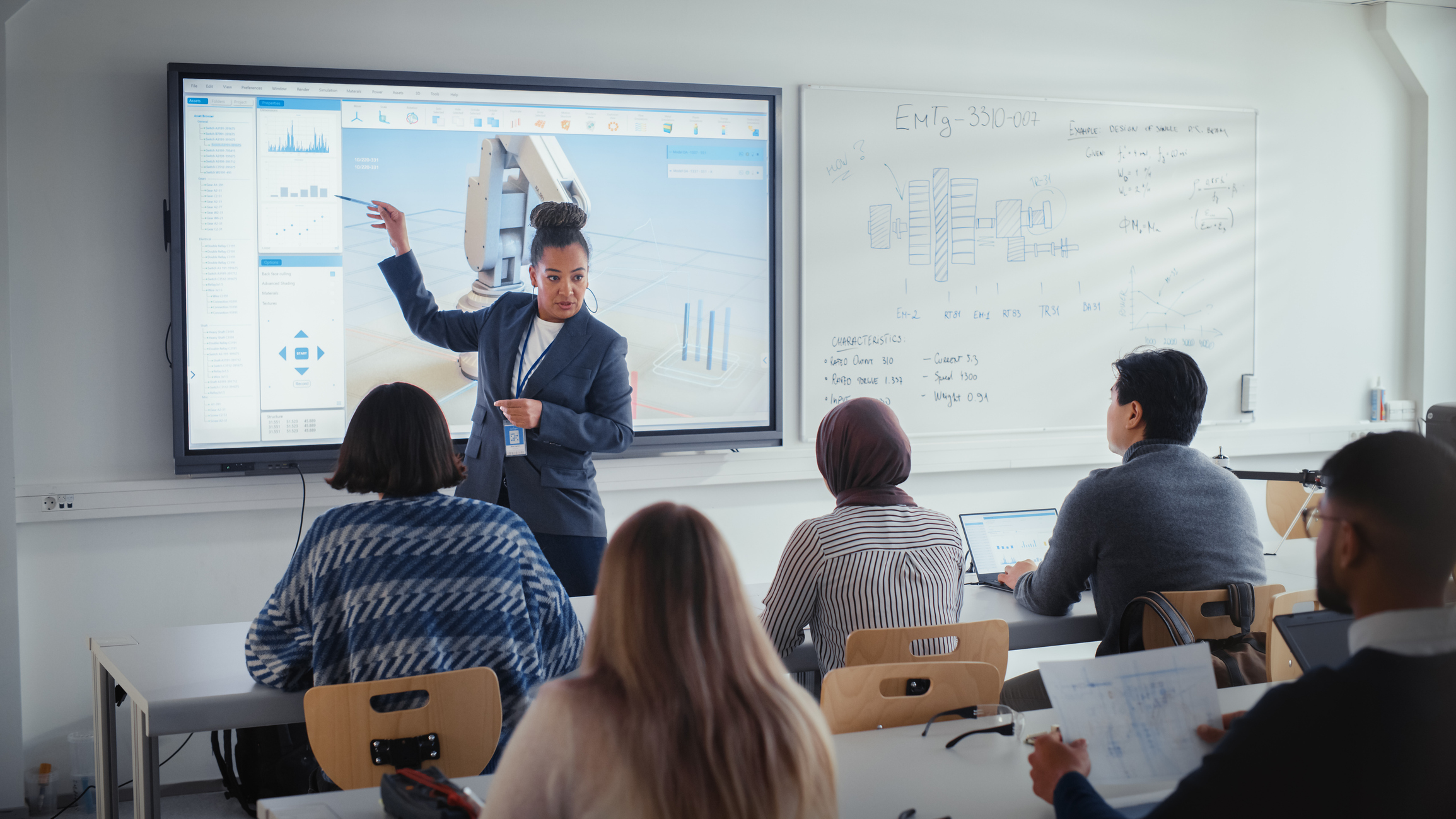 Instructor pointing at a large screen showing 3D BIM software while students watch in a modern classroom