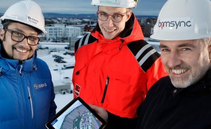 Our founder Havard and 2 employees from Veidekke on a construction site with an ipad on which Catenda Hub is showing the 3d model of that construction