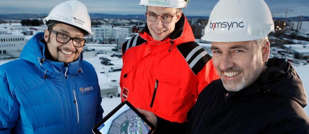 Our founder Havard and 2 employees from Veidekke on a construction site with an ipad on which Catenda Hub is showing the 3d model of that construction