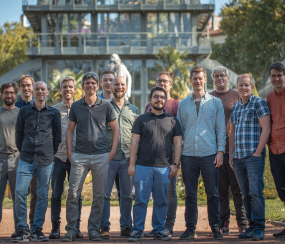 Entire Catenda dev team standing together, smiling at you