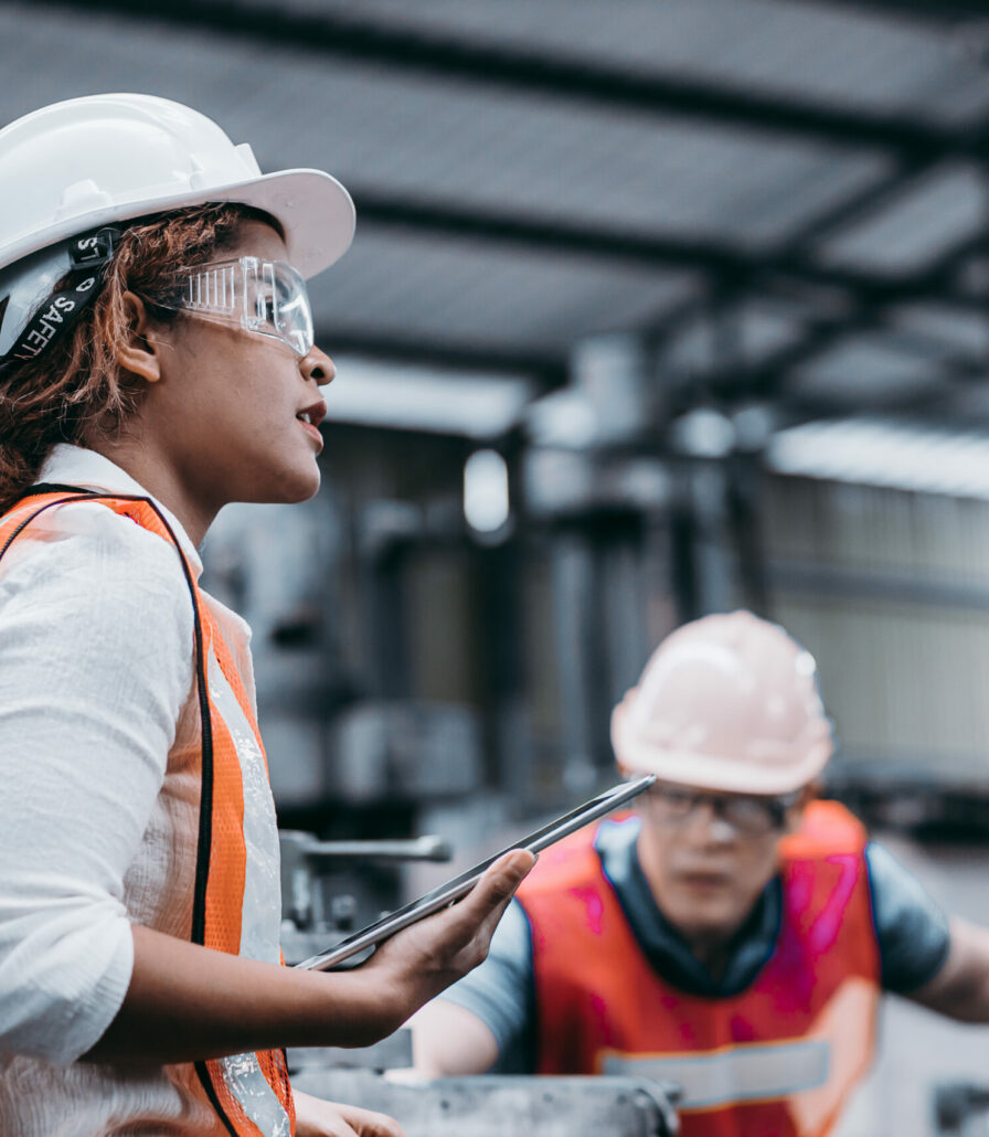 Female industrial engineer wearing a white helmet while standing
