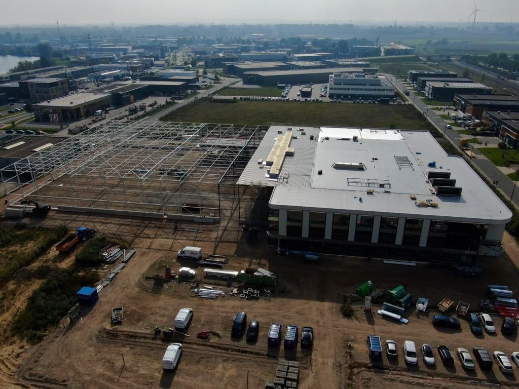 Real-life construction progress showing the building envelope.